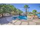 Beautiful backyard with a custom pool featuring rock accents and lush landscaping near the water at 694 W Beechnut Dr, Chandler, AZ 85248