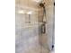 Modern walk-in shower with glass door, tiled walls, niche, and rainfall shower head at 694 W Beechnut Dr, Chandler, AZ 85248