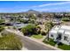 A nice aerial view of the home in a neighborhood setting with mountain views at 7246 E Virginia Ave, Scottsdale, AZ 85257