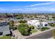 Aerial view of neighborhood homes, mature trees and landscaping with a blue sky at 7246 E Virginia Ave, Scottsdale, AZ 85257