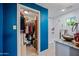 Stylish bathroom features walk in closet, blue accent wall, modern vanity, and tiled shower-tub combo at 7246 E Virginia Ave, Scottsdale, AZ 85257