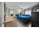 Spacious bedroom features a plush blue bed, sitting area, and view to an adjoining room at 7246 E Virginia Ave, Scottsdale, AZ 85257