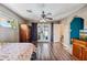 Bright bedroom featuring stylish hardwood floors, a ceiling fan, and direct access to the backyard at 7246 E Virginia Ave, Scottsdale, AZ 85257