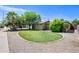 Expansive front yard of the home with fresh green grass and desert landscaping elements at 7246 E Virginia Ave, Scottsdale, AZ 85257