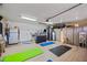 Spacious garage is currently being used as a gym space with vinyl plank flooring and storage cabinetry at 7246 E Virginia Ave, Scottsdale, AZ 85257