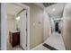Hallway with view to bathroom; showcases wood flooring and neutral wall paint at 7246 E Virginia Ave, Scottsdale, AZ 85257