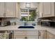 Bright kitchen with white cabinets, backsplash, undermount sink, and stainless steel appliances at 7246 E Virginia Ave, Scottsdale, AZ 85257