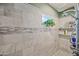 Modern shower stall with marble tile, built-in niche, and rainfall shower head at 7246 E Virginia Ave, Scottsdale, AZ 85257