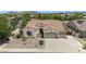 Aerial view showcasing the property's well-maintained exterior, including a three-car garage and desert landscaping at 8068 W Carlota Ln, Peoria, AZ 85383