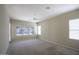 Large bedroom with neutral walls, ceiling fan, carpet flooring, and ample natural light at 8068 W Carlota Ln, Peoria, AZ 85383