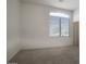 Bright bedroom with a large window and neutral carpet flooring at 8068 W Carlota Ln, Peoria, AZ 85383