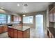 Well-appointed kitchen with ample counter space, an island, and a view into the adjacent living area at 8068 W Carlota Ln, Peoria, AZ 85383