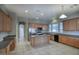 Open concept kitchen features wood cabinets, stainless steel appliances, and a center island, perfect for entertaining at 8068 W Carlota Ln, Peoria, AZ 85383