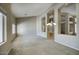 Spacious living room with high ceilings, carpet flooring, and decorative chandelier at 8068 W Carlota Ln, Peoria, AZ 85383