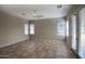 Bright living room with tile flooring, ceiling fan, and sliding glass door to the backyard at 8068 W Carlota Ln, Peoria, AZ 85383