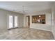Open-concept living room with tile flooring, ceiling fan, and view into the kitchen at 8068 W Carlota Ln, Peoria, AZ 85383