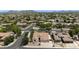 Wide aerial shot of a neighborhood with tree-lined streets and well-maintained houses in a planned community at 8068 W Carlota Ln, Peoria, AZ 85383