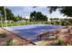 Community basketball court featuring new surface, landscaping, and bench for enjoying the outdoors at 8323 E Peterson Ave, Mesa, AZ 85212