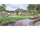 Community common area featuring green space with flowers and trees and multiple benches for residents at 8323 E Peterson Ave, Mesa, AZ 85212