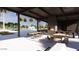 Community outdoor kitchen featuring an outdoor fireplace, ample seating and views of the pool at 8323 E Peterson Ave, Mesa, AZ 85212