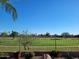 Iron fence enclosed backyard with desert landscaping offers serene views of golf course at 8541 E Krail St, Scottsdale, AZ 85250