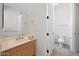 A compact bathroom with a single sink vanity and a separate toilet area at 8541 E Krail St, Scottsdale, AZ 85250