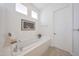 Clean and well-lit bathroom features a built-in tub and shower, next to a door at 8541 E Krail St, Scottsdale, AZ 85250