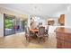 Bright dining room with tile flooring, a wood table, and sliding glass doors at 8541 E Krail St, Scottsdale, AZ 85250