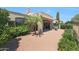 Exterior view of home featuring lush landscaping, covered patio, and outdoor grill at 8541 E Krail St, Scottsdale, AZ 85250