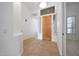 Welcoming foyer featuring tile flooring, a wooden front door, and side windows at 8541 E Krail St, Scottsdale, AZ 85250