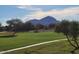Scenic golf course view featuring lush green, paved path and mountain background at 8541 E Krail St, Scottsdale, AZ 85250
