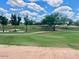 Expansive golf course view features lush green fairways, mature trees, and tranquil water feature at 8541 E Krail St, Scottsdale, AZ 85250