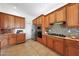 Kitchen featuring stainless steel appliances, mosaic backsplash, and light wood cabinets for a warm feel at 8541 E Krail St, Scottsdale, AZ 85250