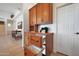 Dry bar featuring wine rack, beverage cooler, light wood cabinets, and granite countertop at 8541 E Krail St, Scottsdale, AZ 85250