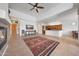Open-concept living room with a fireplace, tile floor, and easy kitchen/dining access at 8541 E Krail St, Scottsdale, AZ 85250