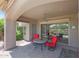 Cozy covered patio with brick pavers, ceiling fan, and comfortable seating offers outdoor living at 8541 E Krail St, Scottsdale, AZ 85250