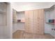Well-organized walk-in closet with built-in shelving, drawers, and clothing racks at 8541 E Krail St, Scottsdale, AZ 85250