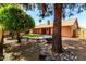 Backyard view showcasing a water feature, rock landscaping, and the home's exterior at 9645 W Kimberly Way, Peoria, AZ 85382
