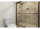 Bathroom featuring tiled shower with built-in seat, safety bars, and decorative accents at 9645 W Kimberly Way, Peoria, AZ 85382