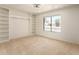 Bedroom with built-in shelving, carpet and view to neighborhood at 9645 W Kimberly Way, Peoria, AZ 85382
