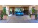 Welcoming clubhouse entrance with tiled flooring, stone accents, glass doors, and colorful floral arrangements at 9645 W Kimberly Way, Peoria, AZ 85382