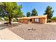Single-story home with a desert landscape, mature tree, and a two-car garage at 9645 W Kimberly Way, Peoria, AZ 85382