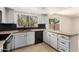 The kitchen features granite countertops, black appliances, and a window with lush landscaping outside at 9645 W Kimberly Way, Peoria, AZ 85382
