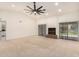 Large living room featuring a fireplace, carpet flooring, and access to the backyard at 9645 W Kimberly Way, Peoria, AZ 85382