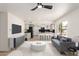 Bright living room with an open-concept kitchen and a modern gray sofa at 9645 W Kimberly Way, Peoria, AZ 85382