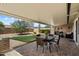 Covered patio with a table and chairs overlooking a landscaped backyard at 9666 W Mountain View Rd # A, Peoria, AZ 85345