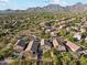 Stunning aerial view of a residential community nestled against a mountain range with desert landscaping at 10252 E Butherus Dr, Scottsdale, AZ 85255