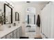 Bright bathroom with gray vanity, modern fixtures, and connecting view to bedroom at 10252 E Butherus Dr, Scottsdale, AZ 85255