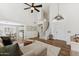Bright living room with high ceilings and a staircase leading to the upper floor at 10252 E Butherus Dr, Scottsdale, AZ 85255