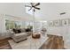 Cozy living room featuring large windows, a comfortable sofa, and an open floor plan at 10252 E Butherus Dr, Scottsdale, AZ 85255